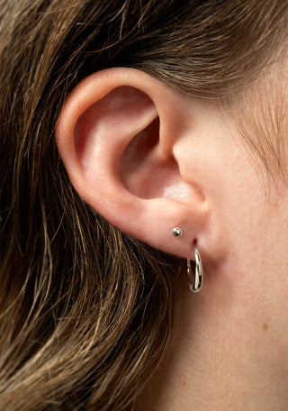 Close-up of a person's ear with earrings