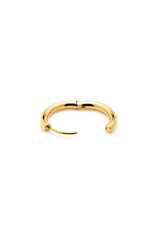 Gold hoop earring on a white background