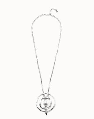 A silver-toned necklace featuring a delicate chain, a large circular ring, and a central oval pendant with a glossy pearl-like bead, displayed against a solid white background.