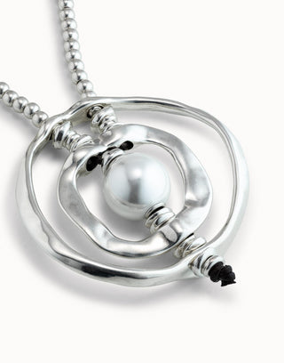 An Unode50 lagre silver-tone pendant with a pearl on a white background