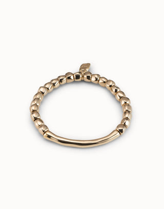 Gold ring with beaded design on a white background