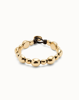 Gold beaded bracelet on a white background