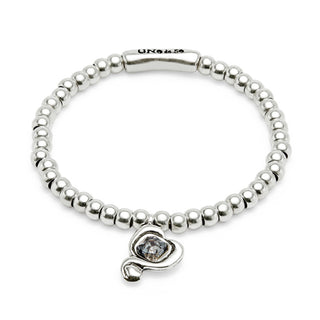 Silver beaded bracelet with a heart-shaped charm on a white background