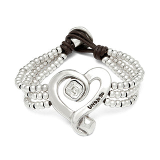 Silver bracelet with heart charm and beads on a white background