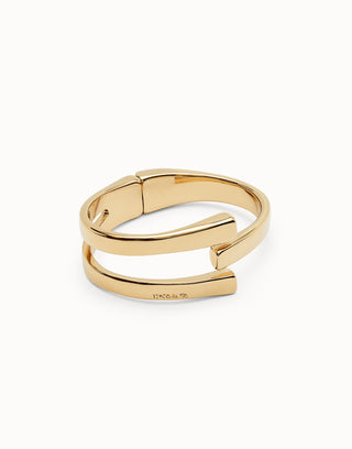 Gold bangle with a white background