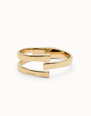 Gold open bangle on a white background