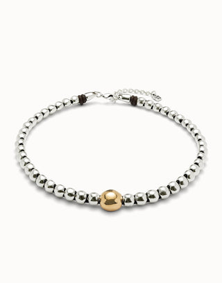Collar necklace with silver and gold beads on a white background