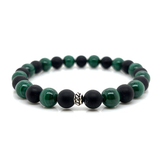 Beaded bracelet with green and black beads on a white background