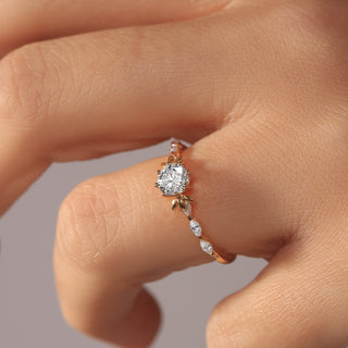 yellow gold ring with a diamond on a finger against a neutral background