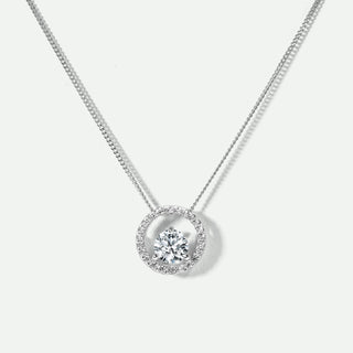 White gold necklace with a round pendant on a light gray background