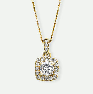 Gold necklace with a diamond pendant on a white background