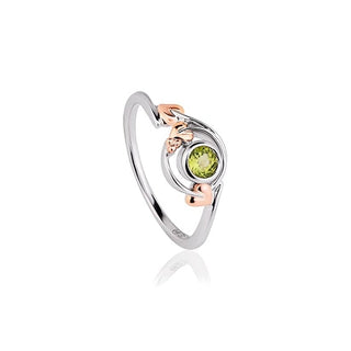 Gold earring with green gemstone and pearl drops on a white background