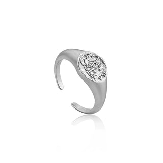 Rose gold ring with intricate design on a white background
