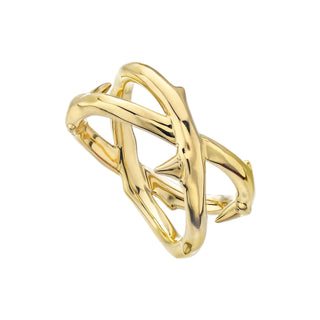 Gold bracelet with a unique design on a light gray background